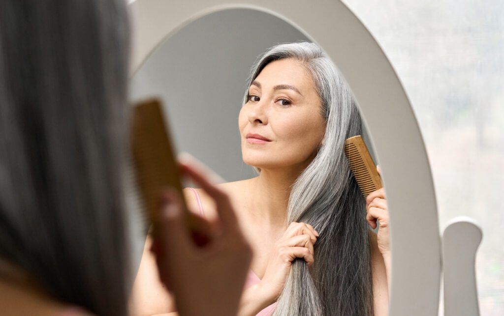 woman brushing her gray hair