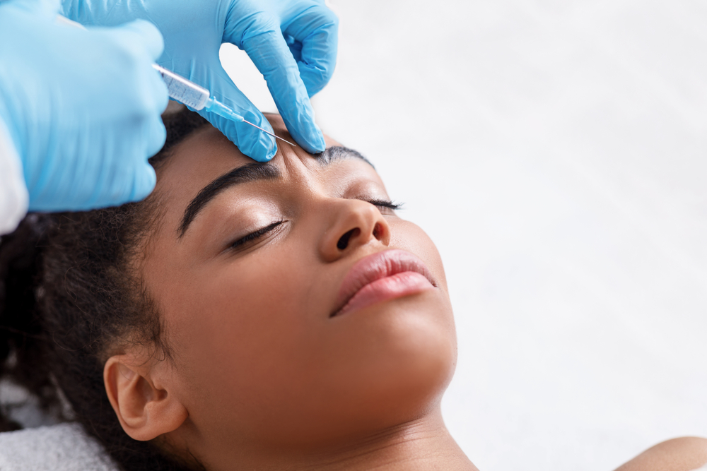 woman receiving injected botox in face