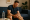 man holding knee in pain, experiencing muscle spasms potentially linked to keto diet.