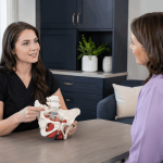 2026_09_mirabilemd.com_img_pelvic_health_consultation_v1.png mirabile md - provider using a pelvic anatomy model during a women’s health consultation.