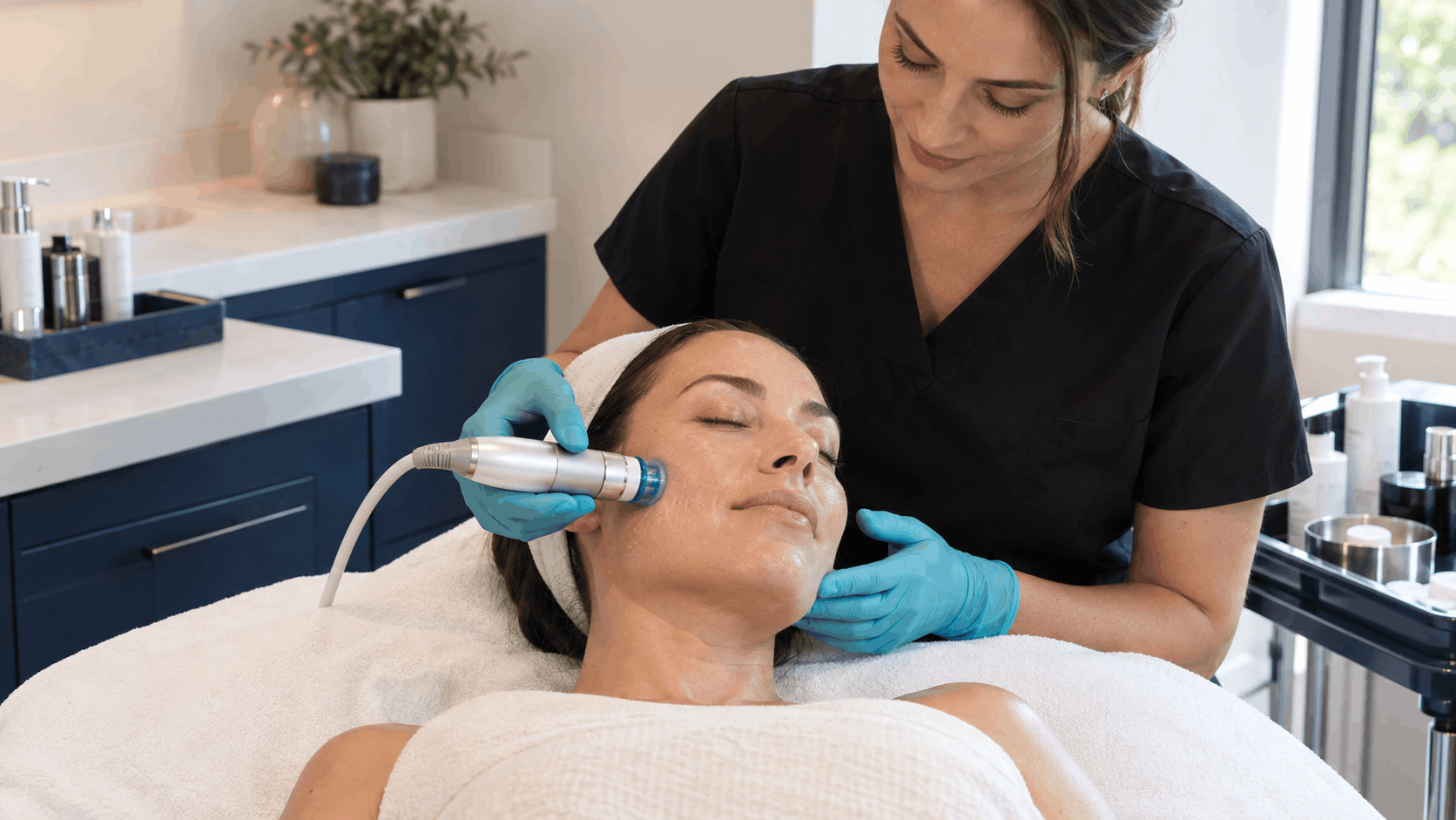 woman receiving a hydrating facial treatment from an aesthetic provider