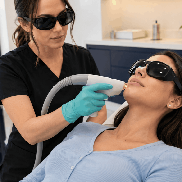 Provider performs a laser facial treatment on a patient wearing protective eyewear in a medical spa setting.